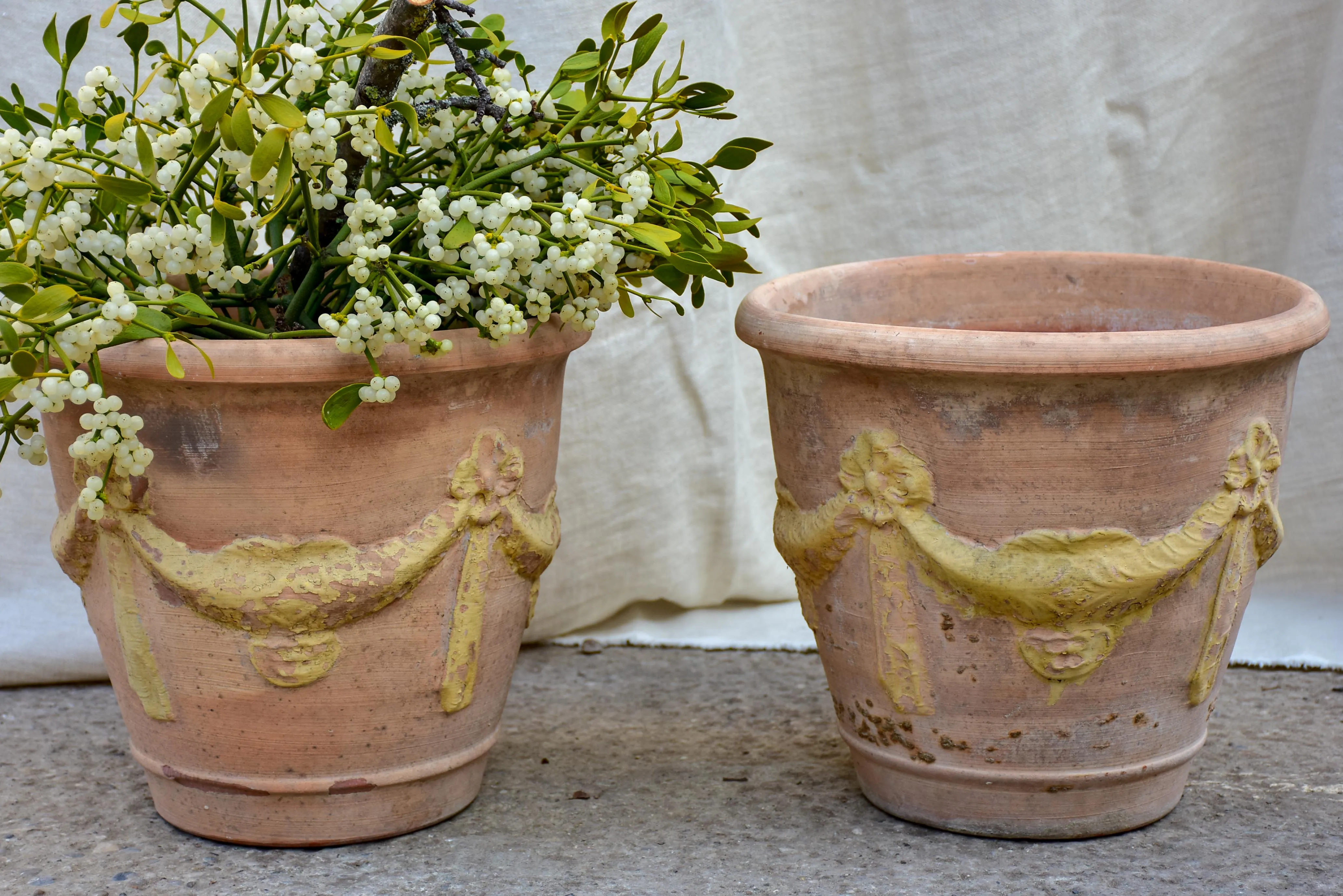 Pair of vintage terracotta garden planters with garlands